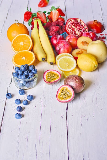 Multi colored summer fruits on white wooden table - summer fruits on rustic white wooden table - healthy eating, copy space, concepts & ideas