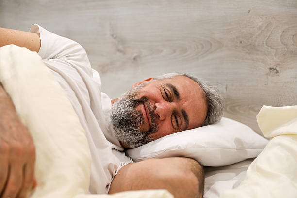 istock Middle-Aged Man Sleeping Peacefully in Bed – Morning Concept 2207641283