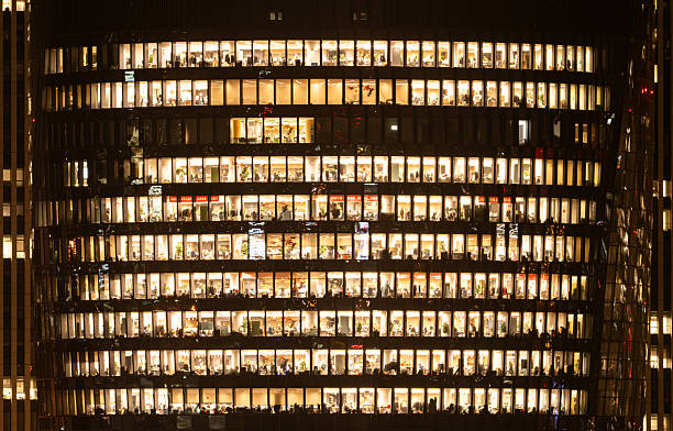 istock People are working overtime in brightly lit office buildings late at night 2207642867