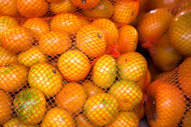 istock ripe tangerines in the net bag 2207643686