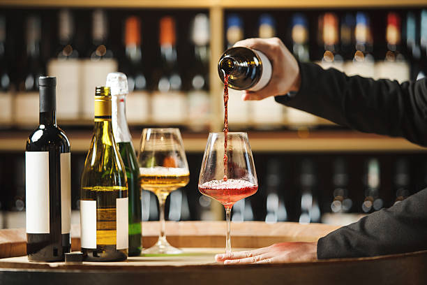 istock Close up Sommelier Pouring Red Wine Into Glass in Underground Cellar 2207643885