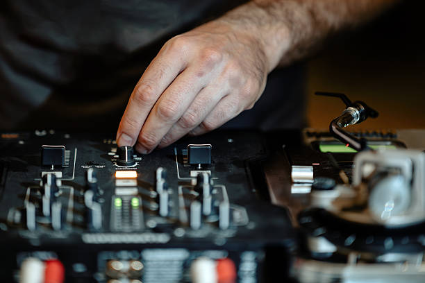 istock DJ mixing music on turntable and mixer at a live event 2207646619
