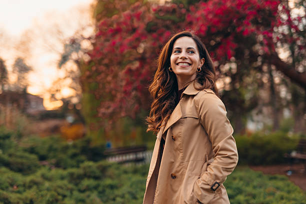 istock Young woman smiling in a park during autumn sunset 2207646853