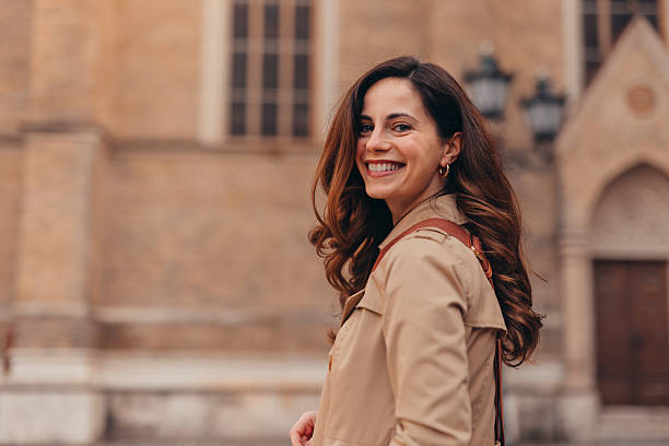 Smiling tourist looking back while visiting a cathedral in an european city