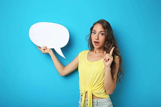 istock Young woman with speech bubble on blue background 2207648848