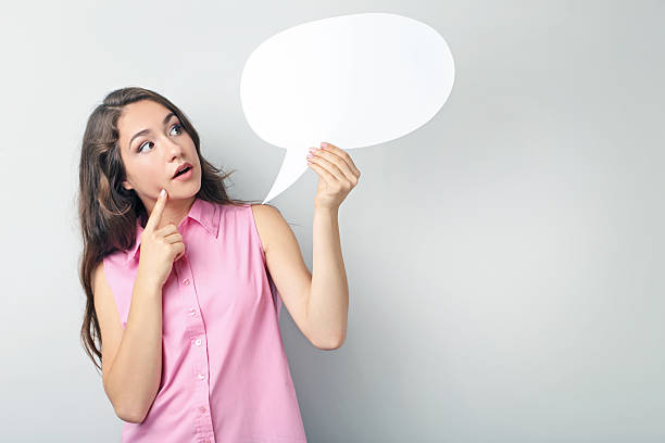 istock Young woman with speech bubble on grey background 2207653786
