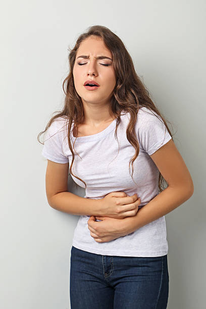 istock Young woman has stomach ache 2207654547