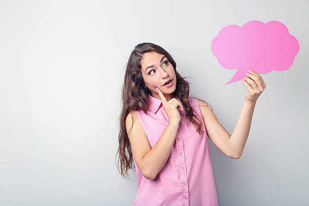 istock Young woman with speech bubble on grey background 2207654696