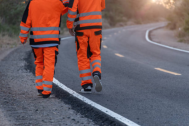 istock Engineer worker wearing safety suite walking survey inspect new road build for final quality check 2207657622