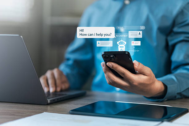 istock Businessman uses Chat Bot to chat with AI technology or artificial intelligence. Conversation with AI intelligent robot system to analyze data. Chatbot helps to solve work problems. 2207658790