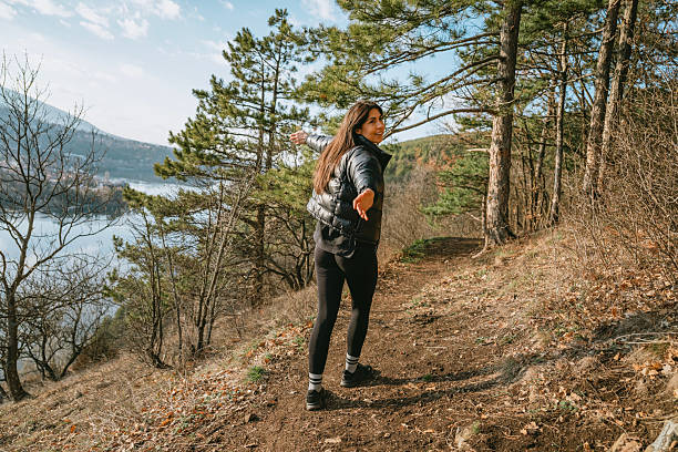 Hiker Woman walking in a pine forest in the spring  mountain