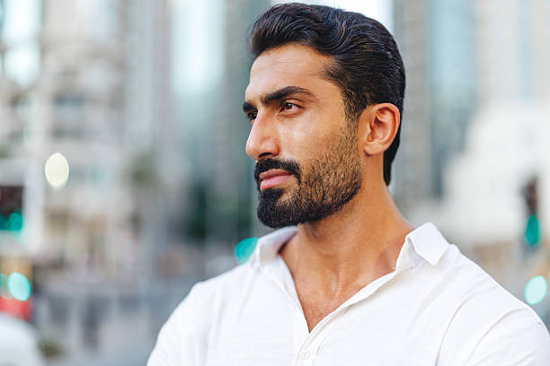 istock Thoughtful Middle Eastern Man in White Shirt in Urban Dubai Setting 2207665515