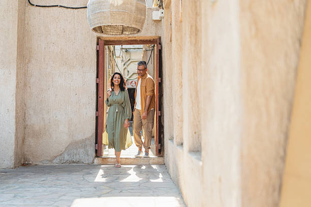 istock Middle Eastern Couple Exploring Old Dubai in Sunlit Traditional Alleyway 2207666053