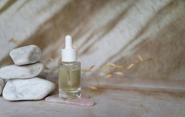 istock Anti aging face serum and jade roller on shadows background 2207666896
