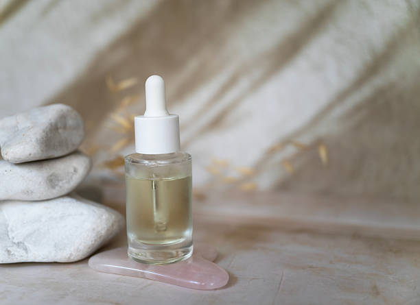 istock Anti aging face serum and jade roller on shadows background 2207666899