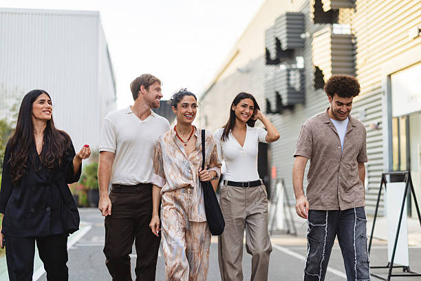 istock Diverse Young Adults in Casual Chic Outfits Strolling Outdoors in Modern Urban Setting 2207667235