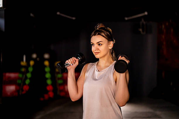 istock Woman working out with dumbbells 2207669155