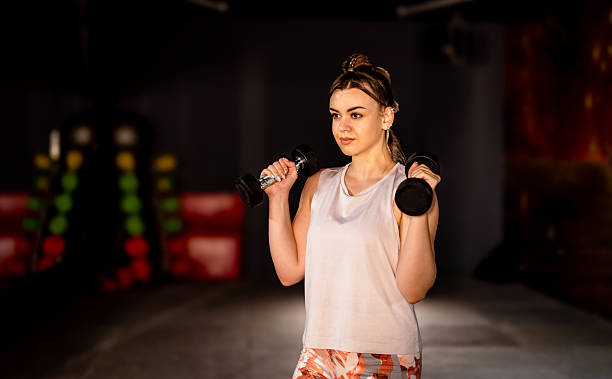 istock Woman working out with dumbbells 2207669212