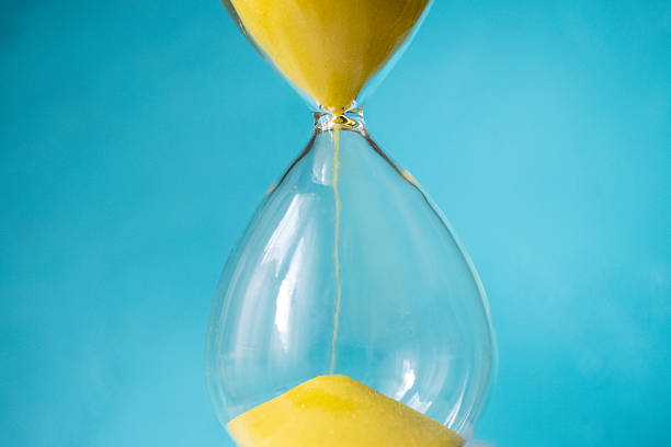 istock yellow hourglass on wooden background 2207669788