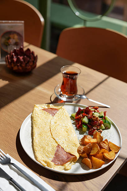 istock Pastrami omelette, Turkish tea, salad and potato wedges. 2207671605