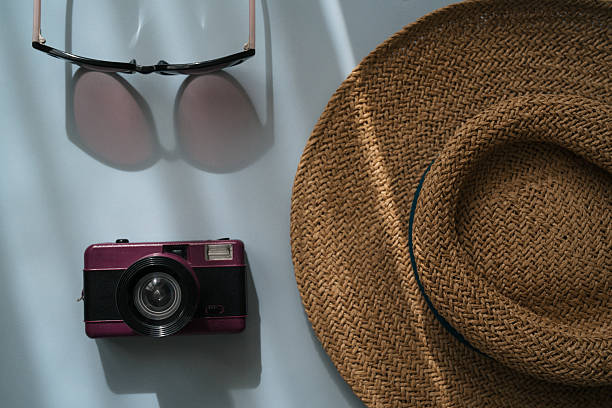 istock Flat lay traveler accessories on blue background, retro camera, straw hat, sunglasses and mobile phone. Top view travel, vacation, holiday concept. Summer background. 2207672243