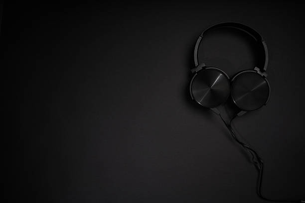 istock black headphones on a black background 2207672989