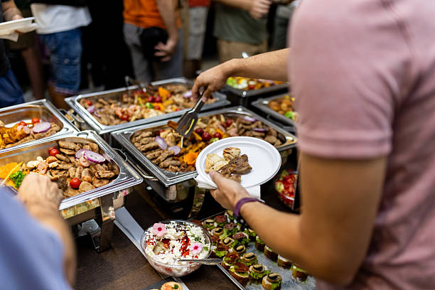 istock Guests enjoy a diverse buffet with assorted dishes at a social gathering in a festive setting 2207673088