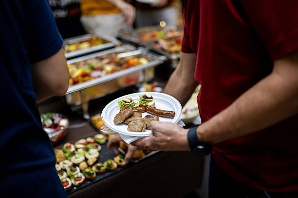 istock Guests enjoying gourmet appetizers at a lively gathering with a buffet in an indoor setting 2207673155