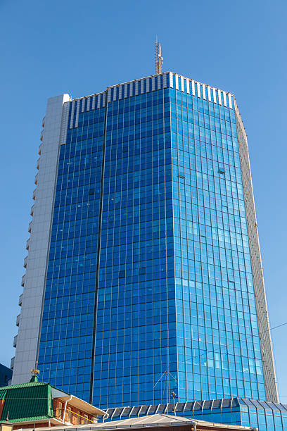 istock Modern glass skyscraper standing tall against clear blue sky 2207674213