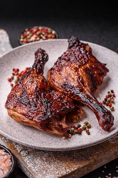istock Duck, chicken leg or thigh grilled on a dark concrete background 2207674328