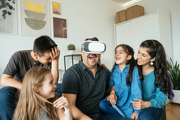 istock Father enjoying VR headset while spending time with family at home 2207675140