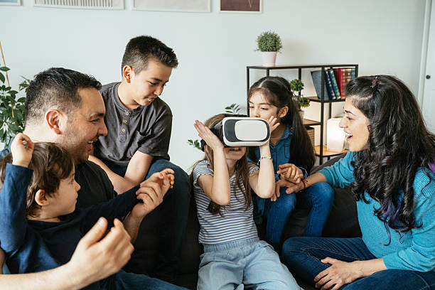 School kids enjoying VR headset while spending time with parents at home