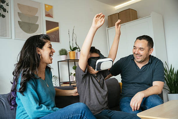 istock Son enjoying VR headset while spending time with parents at home 2207675227