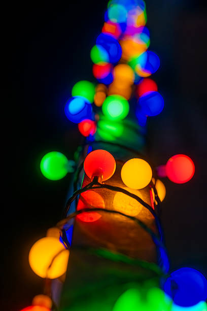 istock Colorful string lights illuminate a tall structure at night during a festive event in a vibrant location 2207677345