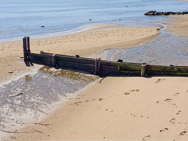 Wood jetty protecting against beach erosion, in Provincetown harbor, Cape Cod.