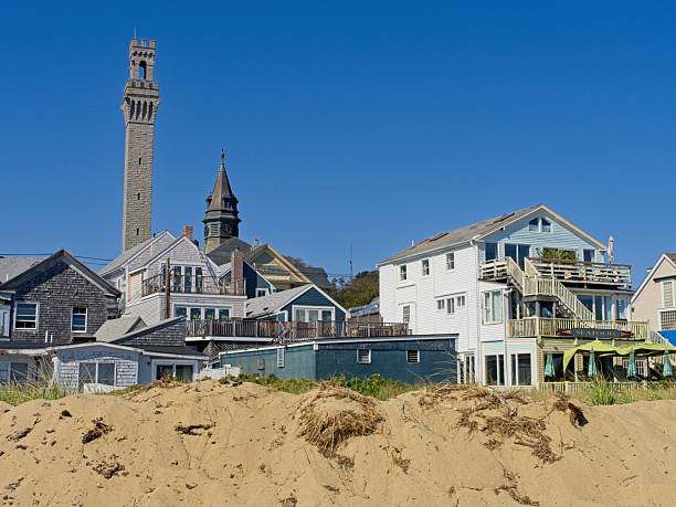 istock Vacation rentals, shops and Pilgrim Monument behind a sand dune 2207678250