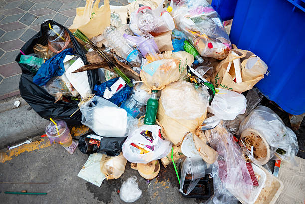 istock Overflowing Trash Pile on Urban Street 2207678317