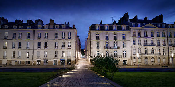 Night view of the street of the buildings on Quai Durenne Street in the Ile Feydu area of ​​Nantes - France.
