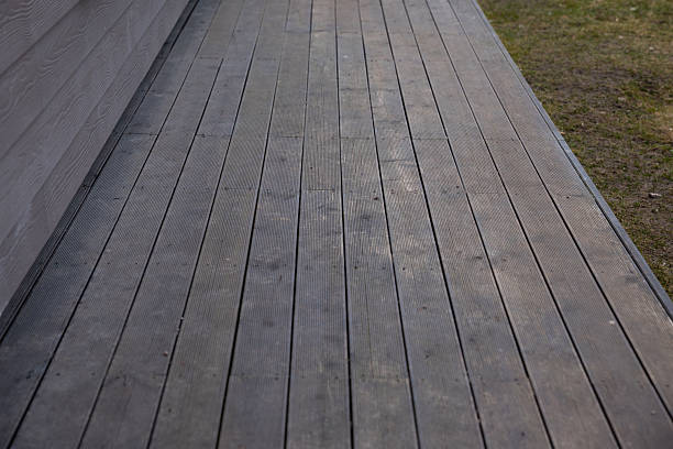 istock Wooden Deck with Horizontal Siding and Adjacent Grass Area 2207680797