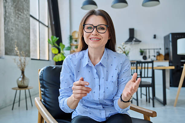 istock Middle aged confident woman looking at webcam, having video conference 2207681160