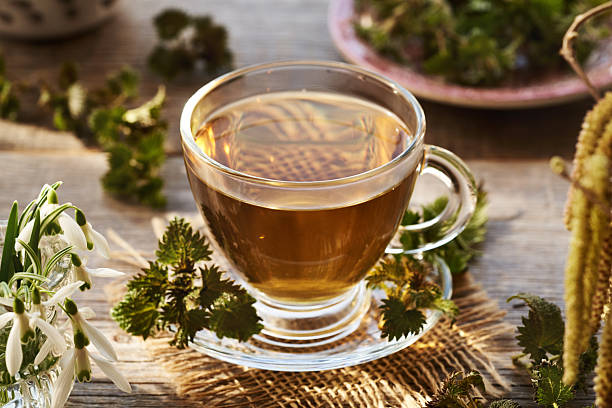istock Nettle tea in a glass cup in spring. Herbal medicine. 2207682654