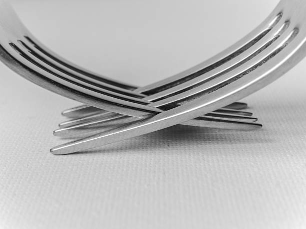 istock Two forks are crossed over each other, creating a unique and interesting design 2207683674