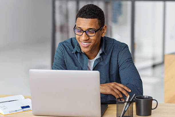 istock Smiling african american man working on laptop 2207683796