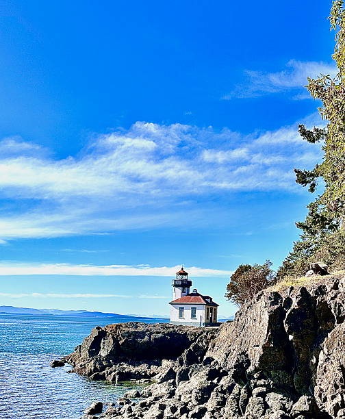 istock Lighthouse on a rocky outcropping 2207683906