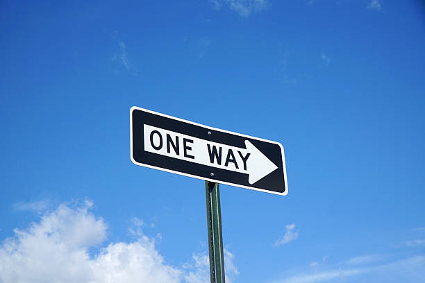 istock one way sign in front of blue sky and white cloud 2207683955