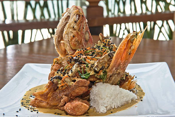 istock Huachinango curry, freshly prepared whole red snapper or snapper Thai style with tamarind sauce and rice 2207684122