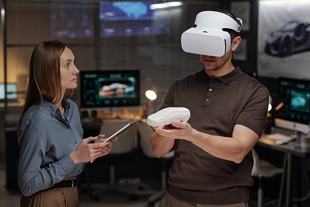 istock Looking at colleague with VR headset 2207685080