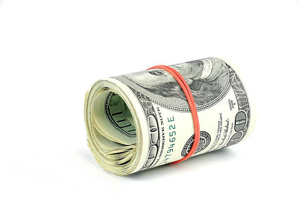 istock roll of hundred USA dollar bills with red rubber 2207685284