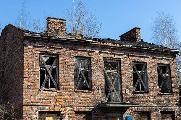 istock Corner View of Abandoned Brick Building with Damaged Roof 2207685509