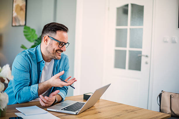 istock Smiling businessman having video call at home office 2207685845